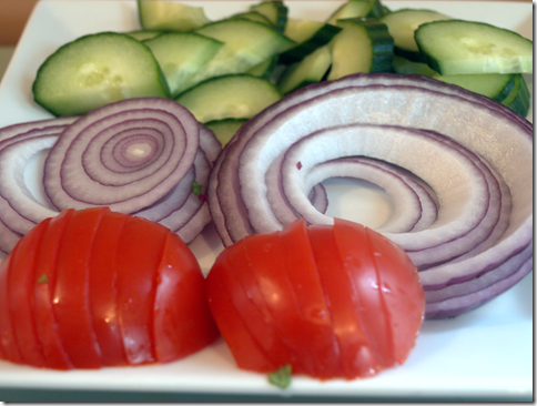 preping cucumbers, red onions, tomatoes