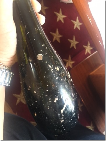 wine bottle with barnacles